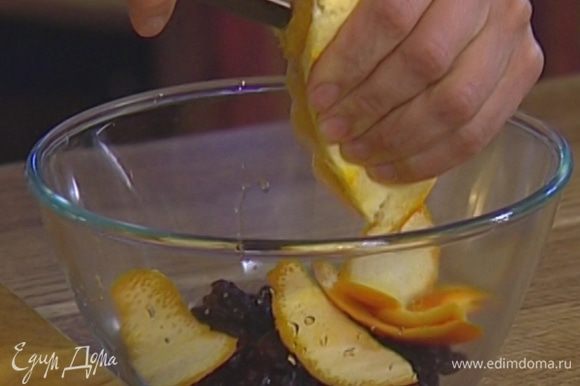 Изюм залить апельсиновым соком, добавить половину срезанной с апельсина цедры, 2–3 ст. ложки кипятка и все перемешать.