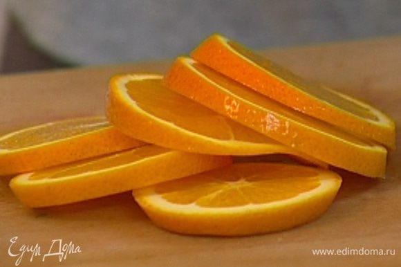 Апельсин нарезать кружками вместе с кожурой.