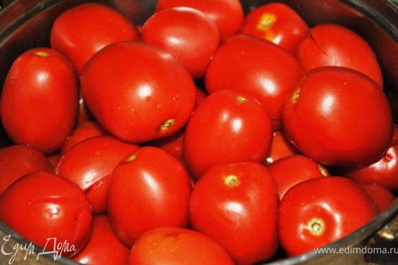 2 кг помидоров (выбрать помельче и потверже) вымыть, сделать надрезы, сложить в кастрюлю и залить кипятком. Накрыть крышкой и оставить на 20 мин.