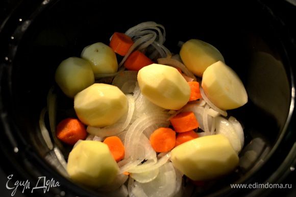Мясо сложить в слоукукер, затем лук, картофель и морковь.