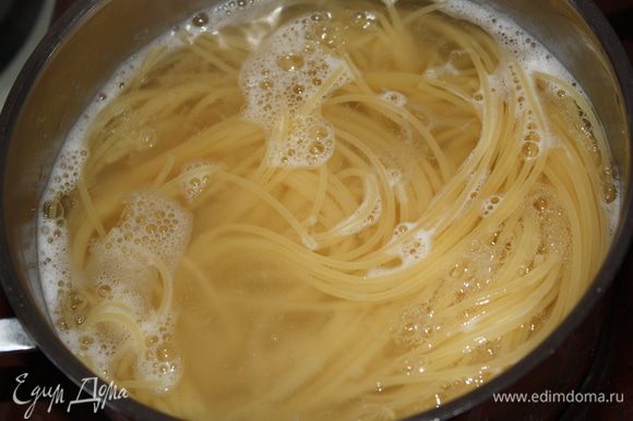 Тем временем в подсоленной воде отвариваем спагетти. Сливаем воду и добавляем 3 ст. л. оливкового масла.