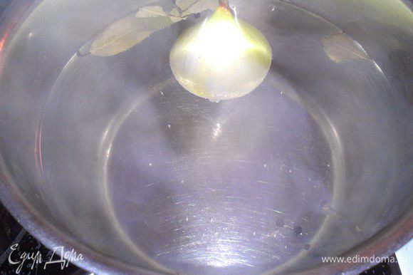 В кастрюлю с кипящей водой положить лавровый лист, перец горошком и половину луковицы.