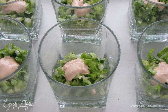 В широкие стаканы выложить салатную смесь. Добавить немного заправки.