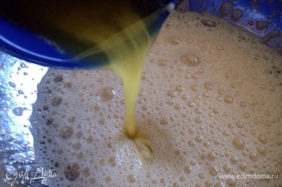 Взбить яйца с сахаром и ванильным сахаром. Затем аккуратно влить растопленное масло, хорошо перемешать.