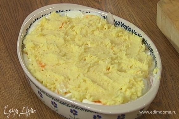 В картофельное пюре добавить горчицу, все вымешать и выложить на рыбу с соусом и яйцами, равномерно распределить.