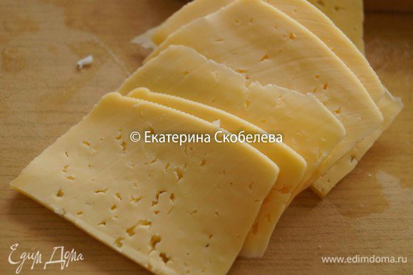 Сыр нарезать тонкими пластинами.