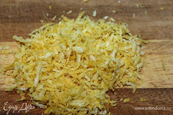 При помощи сырной терки снимаем цедру лимона.