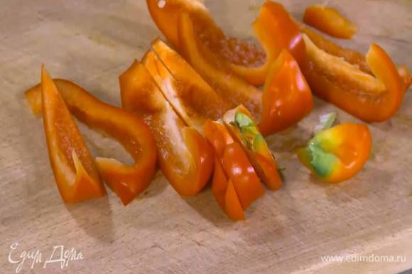 Сладкий перец, удалив плодоножку с семенами, нарезать крупными полосками.