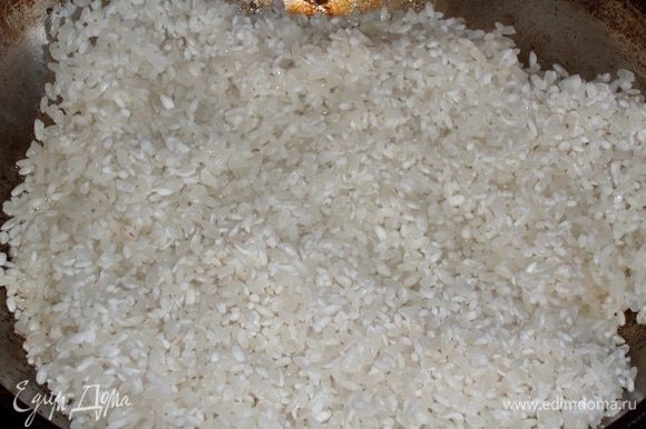 В раскаленную сковороду наливаем 2 ст. л. растительного масла. Высыпаем промытый рис ТМ «Националь».
