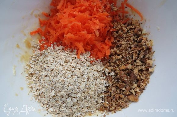 Морковь натереть на крупной терке, грецкие орехи мелко нарезать. Добавляем морковь, орехи и овсяные хлопья к масляно-яичной смеси, перемешиваем.