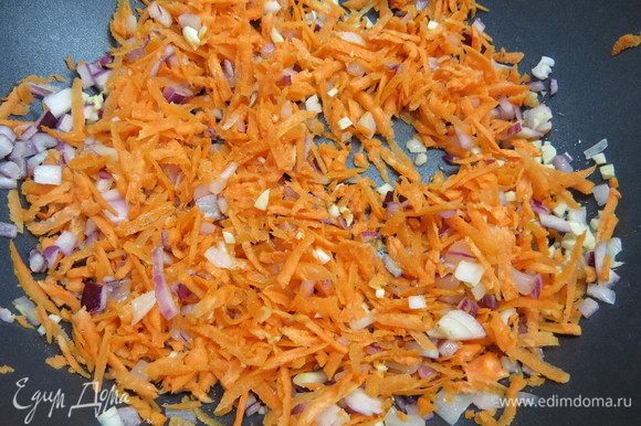 Морковь натереть на крупной терке, добавить в сковороду к луку и чесноку.