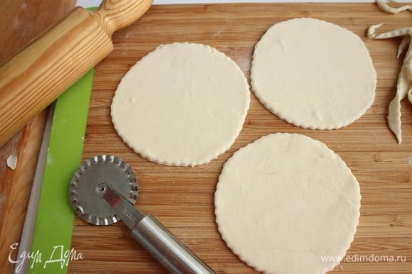 С помощью колесика для пиццы вырезать из слоеного теста 3 кружочка по размеру поверхности формочек. Предварительно тесто нужно немного раскатать.