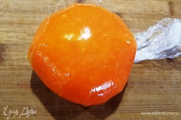 Поднимая пленку, оборачиваем морковкой шарики. Затягиваем края пленки и убираем заготовки в морозильную камеру на 15 минут.