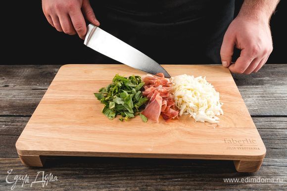 Нарежьте ветчину и базилик, используя для этого разделочную доску Faberlic by Julia Vysotskaya. На терке натрите сыр.