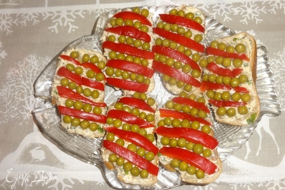Украсить бутерброды полосками сладкого красного перца и зеленым горошком.