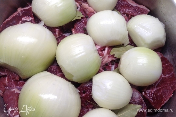 Луковицы большие режем на половинки, малые целиком оставляем, укладываем на мясо и плотно прижимаем.