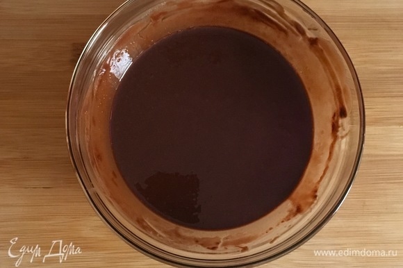 Сливочное масло соедините с темным шоколадом и растопите на водяной бане до полного объединения. Охладите массу в течение 3–5 минут. Разогрейте духовку до 180°C. Застелите форму для выпечки бумагой и слегка смажьте сливочным маслом.