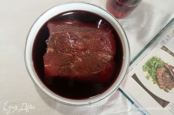 Перекладываем мясо в эмалированную емкость, заливаем вином, накрываем крышкой и оставляем мариноваться на 1 час.