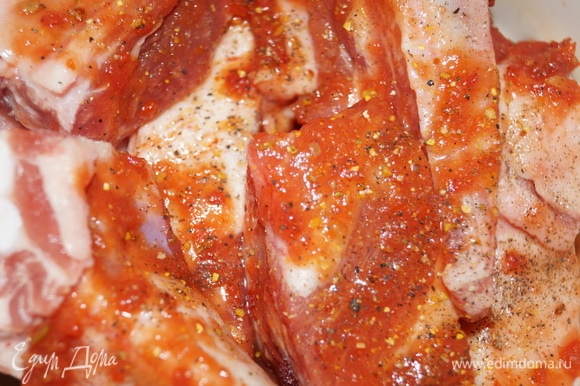 Ребрышки отделите от грудинки так, чтобы на них оставалось и мясо, и сальце, разрежьте их на кусочки грамм по 100. За ранее замаринуйте свиные ребрышки с мясом в чесночном кетчупе, посолите, наперчите, добавьте любимые молотые специи для свинины. Закройте крышкой и уберите на 1–2 дня в холодильник.