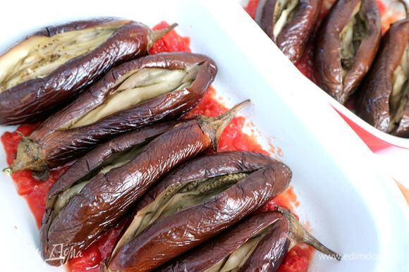 Дно жаропрочной формы покрыть помидорной пассатой, добавить 2–3 ст. л. оливкового масла, поместить в форму баклажаны.