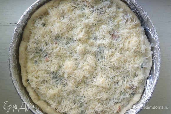 Посыпать начинку оставшимся сыром. Поставить пирог в горячую духовку (180°C) на 30–35 минут.