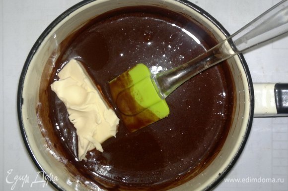 В слегка остывшую шоколадную массу добавить сливочное масло, перемешать. Остудить глазурь до комнатной температуры.