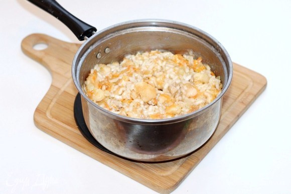 Выкладываем лук с морковью в кастрюлю с отваренным рисом. Добавляем 1 ст. л. соевого соуса, сливочное масло, мякоть яблок, бульон или воду. Перемешиваем. Вместо соли — соевый соус.