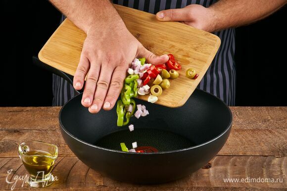 Разогрейте в сковороде 2 ст. л. оливкового масла. Выложите измельченный чеснок, перец чили, шалот и оливки, прогрейте, чтобы масло напиталось ароматами.