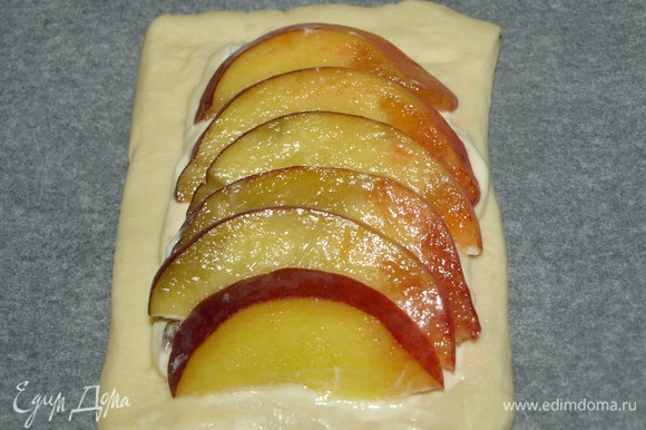 Небольшие твердые персики хорошо вымыть, просушить, разрезать на две части и удалить косточку. Нарезать персик слайсами. Выкладываем слайсы на сырную начинку.