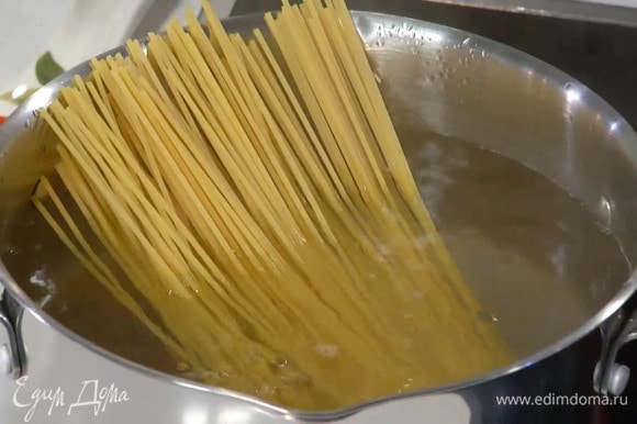 Спагетти отваривать в подсоленной кипящей воде на пару минут меньше, чем указано на упаковке, затем воду слить и сохранить.